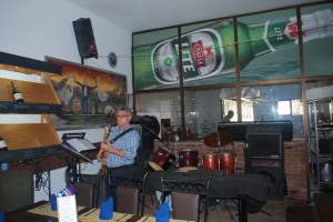 Stiggy practicing his bass inside one of his restaurants