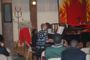 Adelina's assisting Randy Stubbs with page turns during Ian's recital